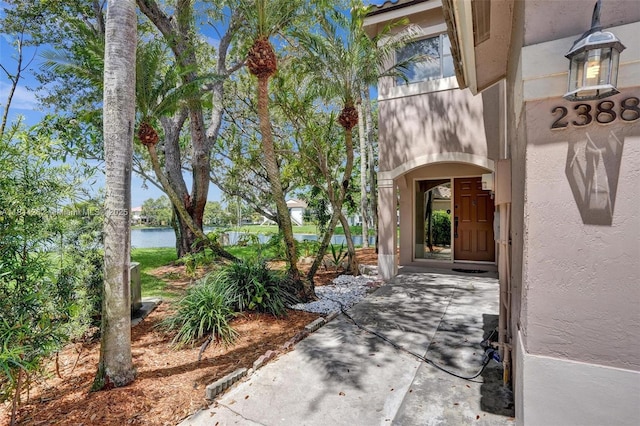 2388 NW 97th Way, Pembroke Pines, FL 33024 - property entrance with a water view and stucco siding