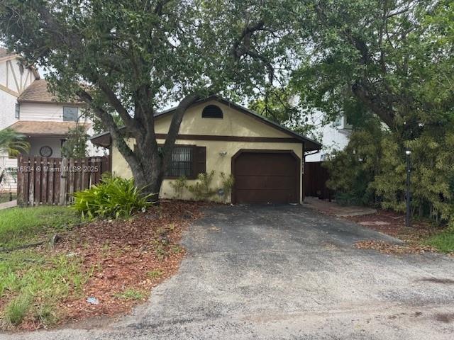 10626 SW 148th Ave Dr, Miami, FL 33196 - view of front facade featuring a garage, asphalt driveway, and stucco siding