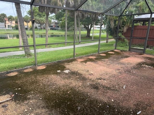 10626 SW 148th Ave Dr, Miami, FL 33196 - view of green lawn featuring a lanai and a water view