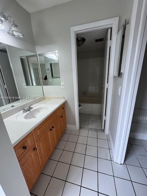 10626 SW 148th Ave Dr, Miami, FL 33196 - full bathroom with vanity, tile patterned flooring, baseboards, and shower / washtub combination