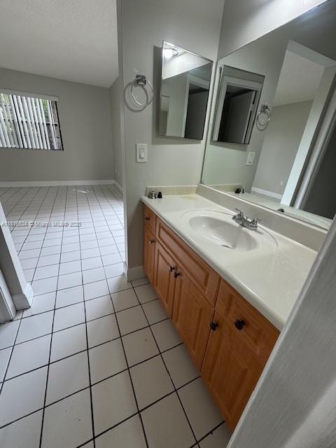 10626 SW 148th Ave Dr, Miami, FL 33196 - bathroom featuring tile patterned floors, vanity, and baseboards