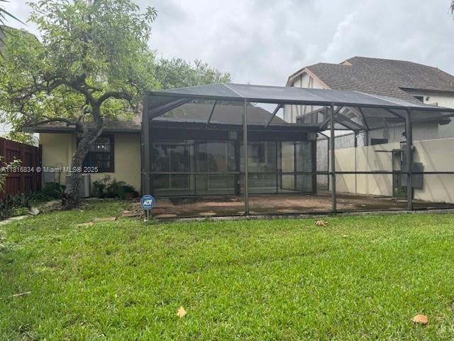 10626 SW 148th Ave Dr, Miami, FL 33196 - rear view of house with stucco siding and glass enclosure