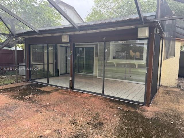 10626 SW 148th Ave Dr, Miami, FL 33196 - back of house featuring a lanai and a sunroom