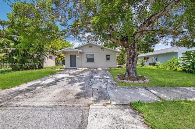 6359 SW 1st St, Margate, FL 33068 - view of front facade with concrete driveway, a front yard, and central AC unit