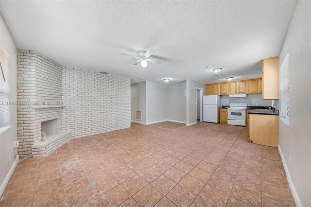 6359 SW 1st St, Margate, FL 33068 - unfurnished living room with ceiling fan, brick wall, baseboards, a textured ceiling, and a sink