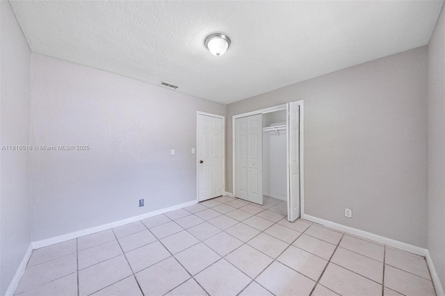 6359 SW 1st St, Margate, FL 33068 - unfurnished bedroom featuring baseboards, a closet, light tile patterned floors, and a textured ceiling