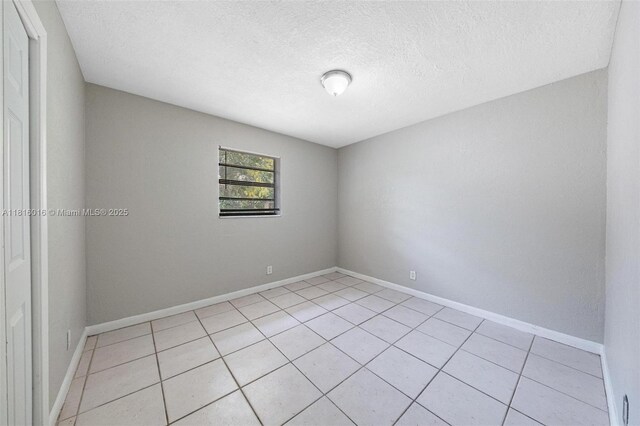6359 SW 1st St, Margate, FL 33068 - unfurnished room with light tile patterned flooring, a textured ceiling, and baseboards