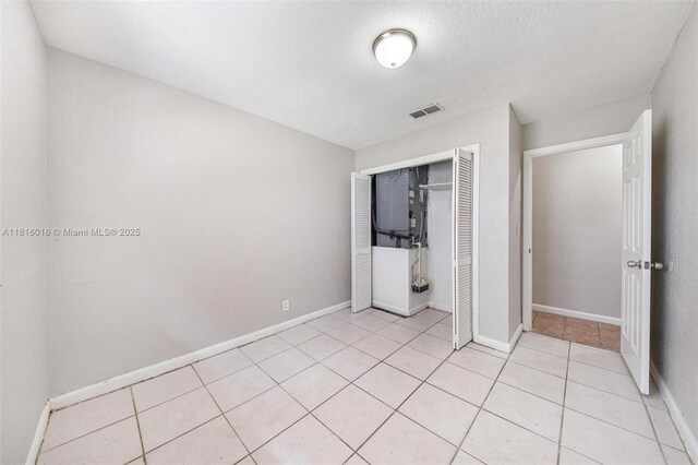 6359 SW 1st St, Margate, FL 33068 - unfurnished bedroom featuring a closet, light tile patterned floors, and baseboards