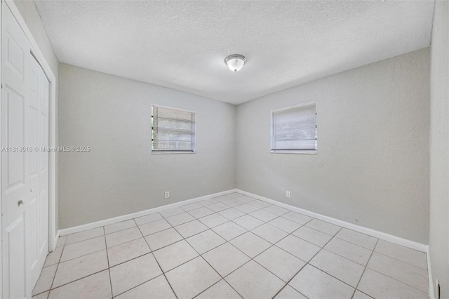 6359 SW 1st St, Margate, FL 33068 - spare room with light tile patterned flooring, a textured ceiling, and baseboards