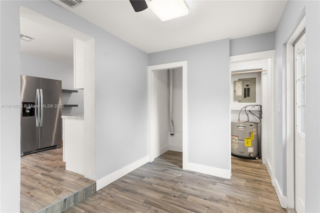 1023 N F St, Lake Worth, FL 33460 - hall featuring water heater, light wood-style floors, electric panel, and baseboards