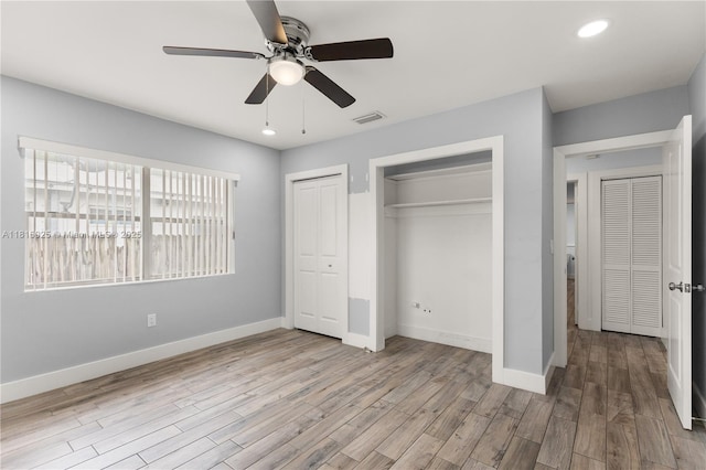 1023 N F St, Lake Worth, FL 33460 - unfurnished bedroom featuring multiple closets, wood finished floors, baseboards, and recessed lighting