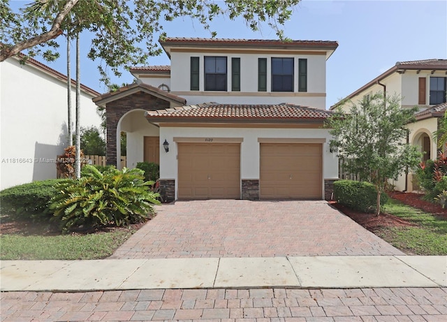 9120 SW 227th Ter, Cutler Bay, FL 33190 - mediterranean / spanish-style home with stucco siding, stone siding, decorative driveway, and a tiled roof