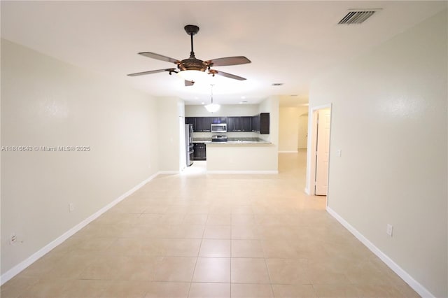 9120 SW 227th Ter, Cutler Bay, FL 33190 - unfurnished living room with a ceiling fan and light tile patterned floors