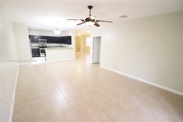 9120 SW 227th Ter, Cutler Bay, FL 33190 - unfurnished living room with arched walkways, ceiling fan, and light tile patterned floors