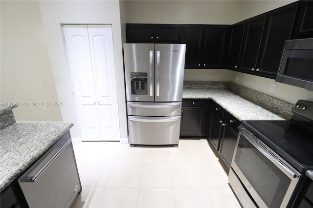 9120 SW 227th Ter, Cutler Bay, FL 33190 - kitchen with stainless steel appliances, dark cabinets, and light stone countertops