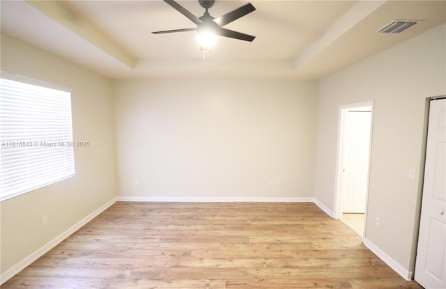 9120 SW 227th Ter, Cutler Bay, FL 33190 - unfurnished bedroom featuring a raised ceiling, light wood finished floors, and a ceiling fan