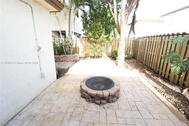 9120 SW 227th Ter, Cutler Bay, FL 33190 - fenced backyard with a patio area and a fire pit