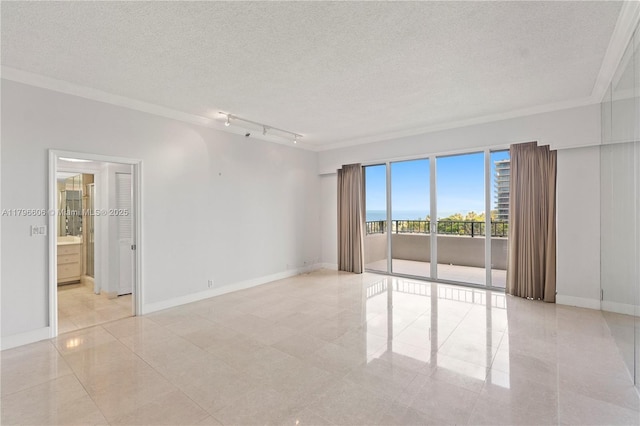 201 Crandon Blvd Unit 633, Key Biscayne, FL 33149 - empty room with a textured ceiling, crown molding, light tile patterned flooring, and rail lighting