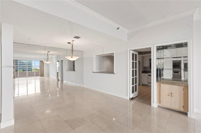 201 Crandon Blvd Unit 633, Key Biscayne, FL 33149 - empty room with ornamental molding, light tile patterned flooring, and a textured ceiling