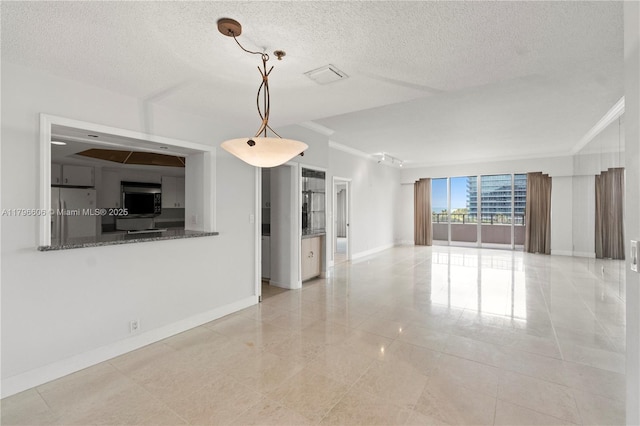 201 Crandon Blvd Unit 633, Key Biscayne, FL 33149 - unfurnished living room featuring ornamental molding, a textured ceiling, and light tile patterned flooring