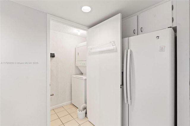 201 Crandon Blvd Unit 633, Key Biscayne, FL 33149 - laundry area with estacked washer and dryer and light tile patterned flooring