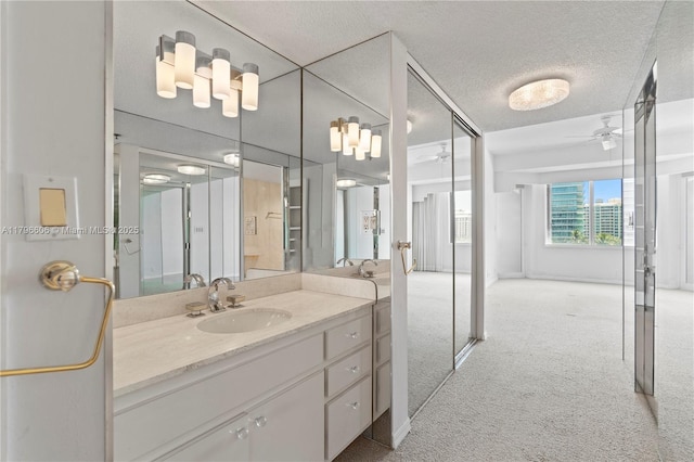 201 Crandon Blvd Unit 633, Key Biscayne, FL 33149 - bathroom featuring a ceiling fan, vanity, and a textured ceiling