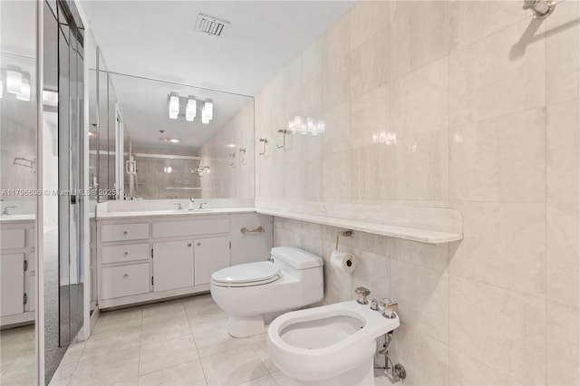 201 Crandon Blvd Unit 633, Key Biscayne, FL 33149 - bathroom featuring tile walls, a stall shower, a bidet, vanity, and tile patterned flooring