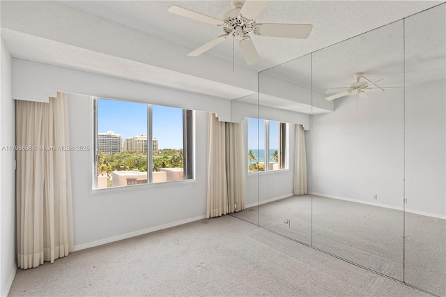 201 Crandon Blvd Unit 633, Key Biscayne, FL 33149 - empty room featuring carpet floors, a textured ceiling, and a ceiling fan