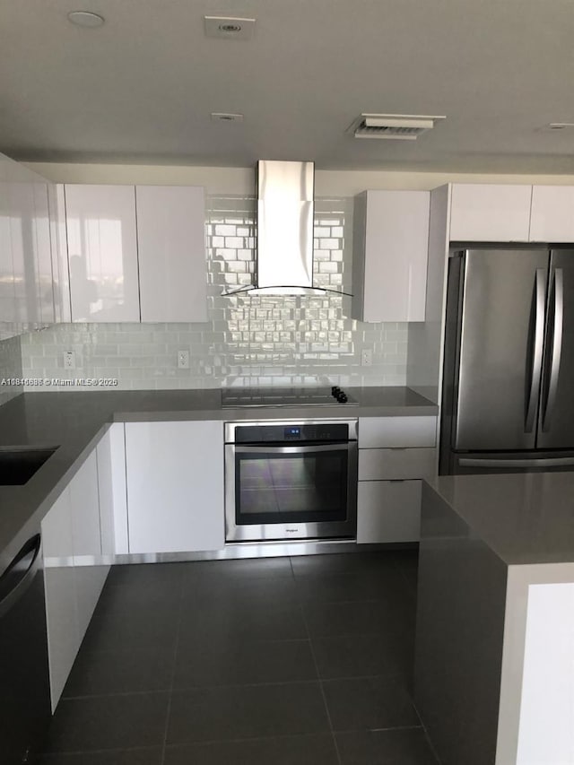 1600 NE 1st Ave Unit 3319, Miami, FL 33132 - kitchen featuring appliances with stainless steel finishes, exhaust hood, modern cabinets, and white cabinetry