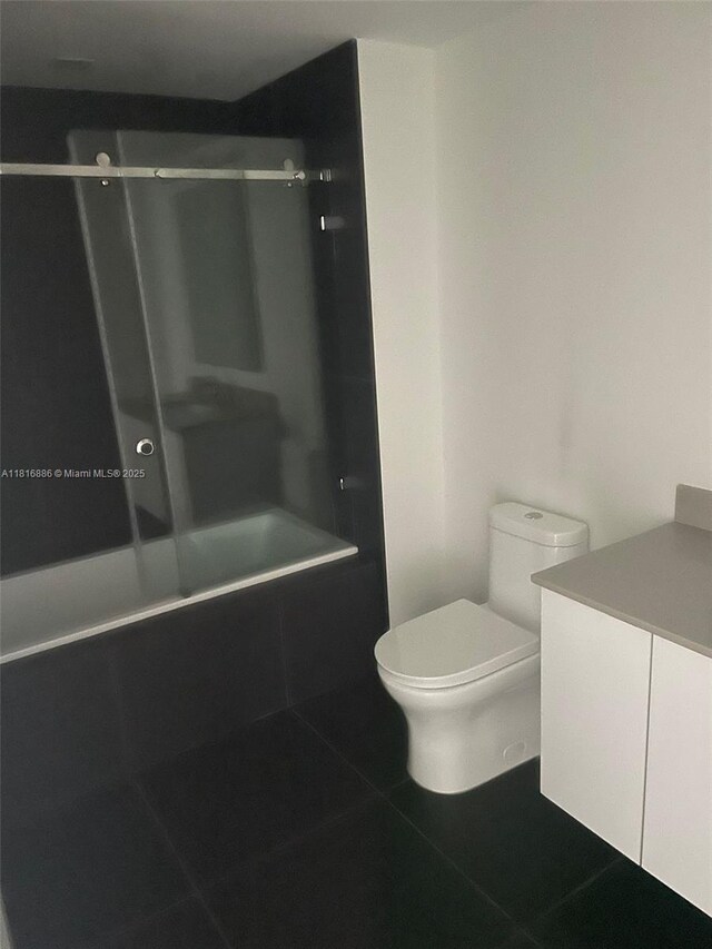 1600 NE 1st Ave Unit 3319, Miami, FL 33132 - full bathroom featuring vanity, bathing tub / shower combination, tile patterned flooring, and toilet