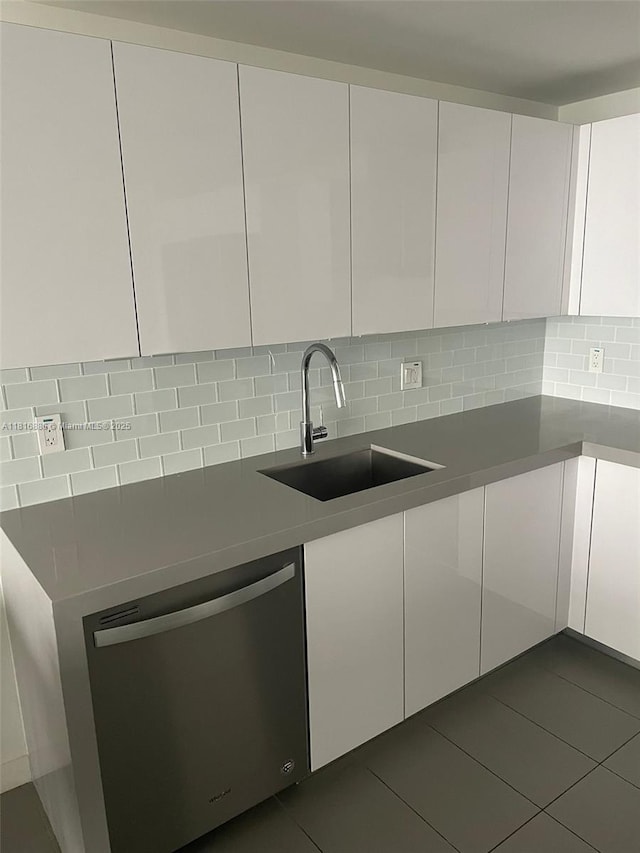 1600 NE 1st Ave Unit 3319, Miami, FL 33132 - kitchen featuring stainless steel dishwasher, a sink, white cabinets, and backsplash