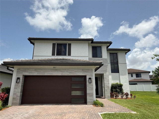 8167 NW 45th St, Doral, FL 33166 - view of front of house featuring stone siding, an attached garage, decorative driveway, and stucco siding