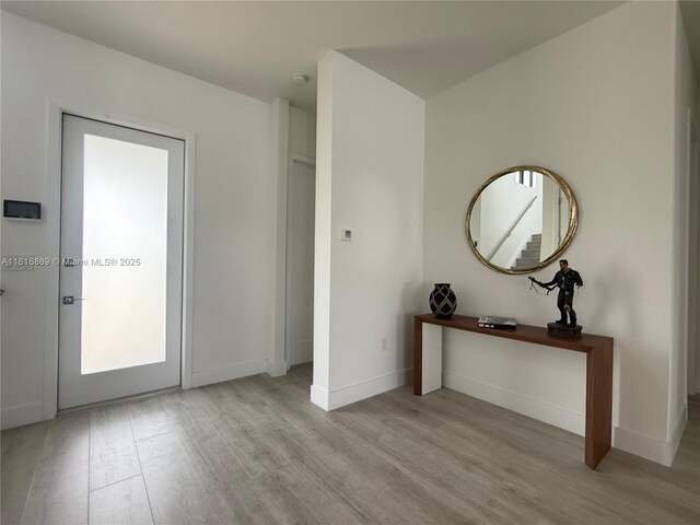 8167 NW 45th St, Doral, FL 33166 - foyer entrance featuring wood finished floors and baseboards