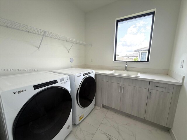 8167 NW 45th St, Doral, FL 33166 - washroom featuring washer and dryer, light marble finish floors, and cabinet space