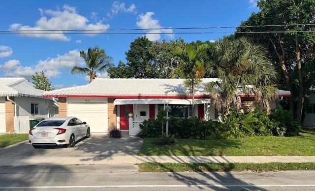 7422 NW 70th Ave, Tamarac, FL 33321 - single story home featuring an attached garage and driveway