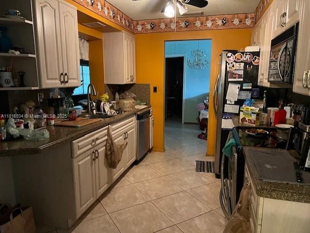 7422 NW 70th Ave, Tamarac, FL 33321 - kitchen with black microwave, a sink, a ceiling fan, stainless steel dishwasher, and dark countertops
