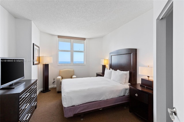 17375 Collins Ave Unit 1908, Sunny Isles Beach, FL 33160 - bedroom with dark carpet, a textured ceiling, and baseboards