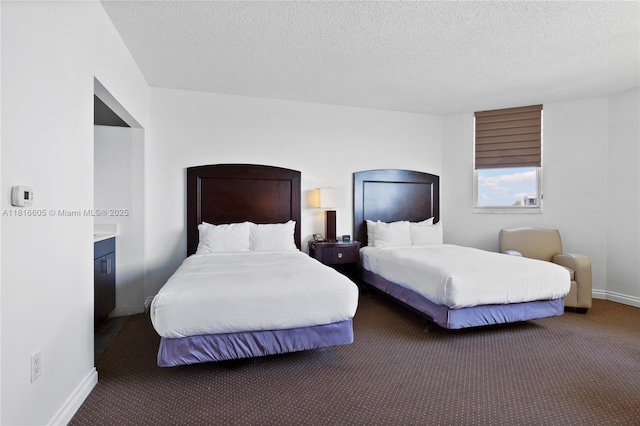 17375 Collins Ave Unit 1908, Sunny Isles Beach, FL 33160 - carpeted bedroom featuring baseboards and a textured ceiling
