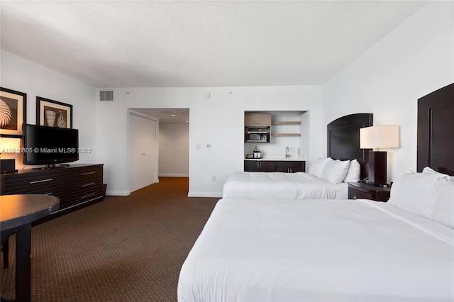 17375 Collins Ave Unit 1908, Sunny Isles Beach, FL 33160 - bedroom featuring dark carpet, baseboards, and a textured ceiling