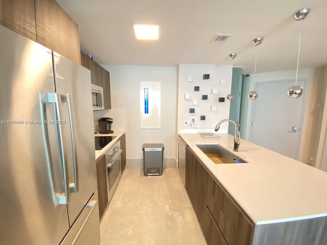 488 NE 18th St Unit 3911, Miami, FL 33132 - kitchen featuring appliances with stainless steel finishes, modern cabinets, light countertops, light tile patterned floors, and decorative light fixtures