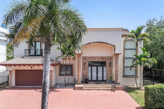 18825 N Bay Rd, Sunny Isles Beach, FL 33160 - mediterranean / spanish-style home with french doors, stucco siding, decorative driveway, and a tile roof