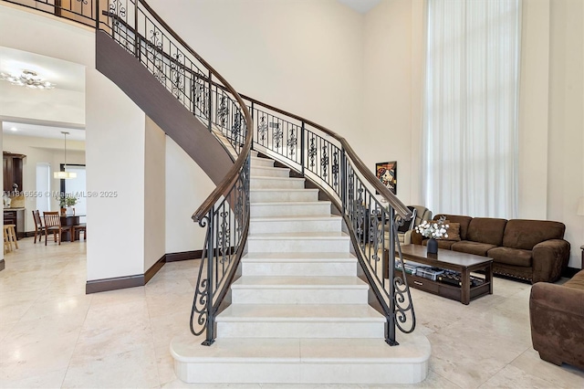 18825 N Bay Rd, Sunny Isles Beach, FL 33160 - stairs featuring a towering ceiling, baseboards, and tile patterned flooring