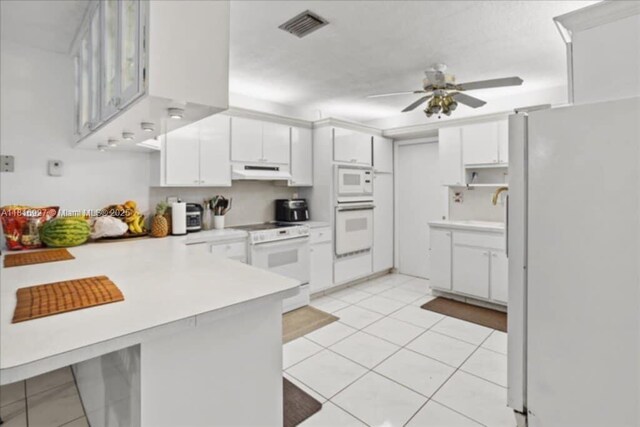 400 NW 41st Ave, Coconut Creek, FL 33066 - kitchen with white appliances, under cabinet range hood, a peninsula, ceiling fan, and light countertops