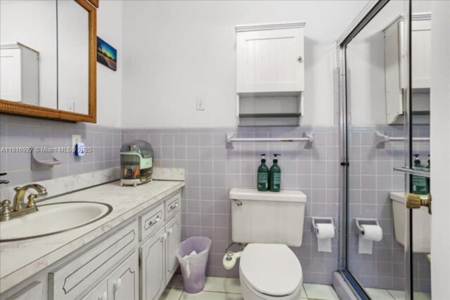 400 NW 41st Ave, Coconut Creek, FL 33066 - bathroom featuring vanity, toilet, a stall shower, tile walls, and a wainscoted wall