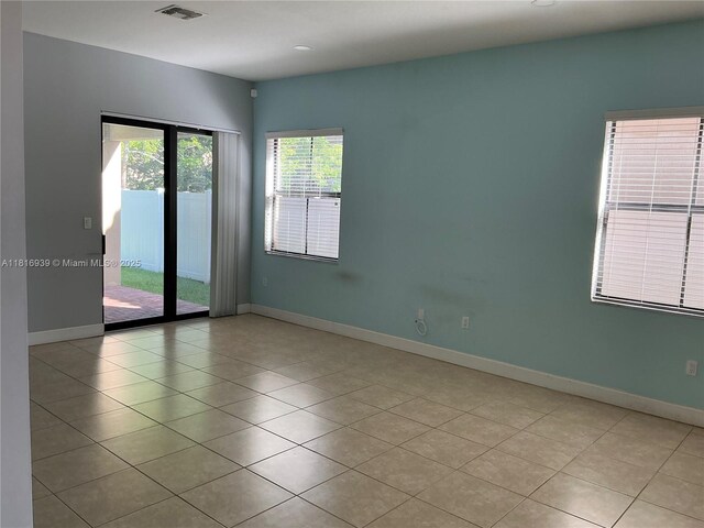 5220 NW 48th Ln, Tamarac, FL 33319 - empty room featuring light tile patterned floors and baseboards