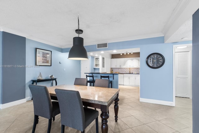 3725 S Ocean Dr Unit 1224, Hollywood, FL 33019 - dining room with crown molding, light tile patterned floors, a textured ceiling, and baseboards