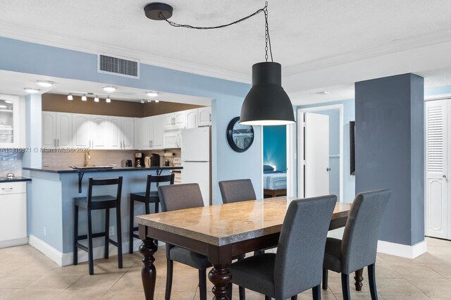 3725 S Ocean Dr Unit 1224, Hollywood, FL 33019 - dining room with ornamental molding, light tile patterned floors, and baseboards