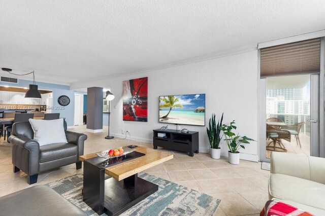 3725 S Ocean Dr Unit 1224, Hollywood, FL 33019 - living area with light tile patterned flooring, crown molding, a textured ceiling, and baseboards