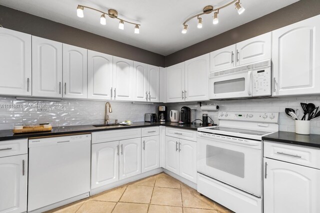 3725 S Ocean Dr Unit 1224, Hollywood, FL 33019 - kitchen featuring white appliances, a sink, dark countertops, and decorative backsplash