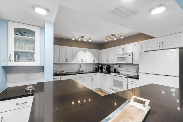 3725 S Ocean Dr Unit 1224, Hollywood, FL 33019 - kitchen featuring white appliances, a sink, dark countertops, decorative backsplash, and white cabinetry
